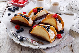 Biscuit tacos with cream filling and fresh berries