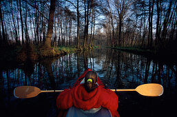 Woman canoeing on river Spree, Spreewald, Brandenburg, Germany
