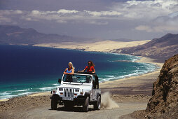 Menschen in einem Jeep oberhalb der Küste, Fuerteventura, Kanarische Inseln, Spanien, Europa