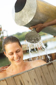 Woman in bathtub, people in water