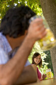 Two young people smiling at each other in beer garden, Munich, Bavaria