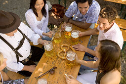 Medium group of people sitting at table in beer garden, Munich, Bavaria