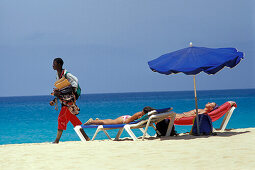 Women lying on deck chairs under sunshade, Beach of Santa Maria, Sal, Cape Verde Islands, Africa