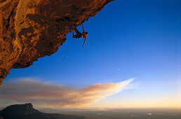 Man doing freeclimbing at overhang, South Africa