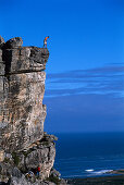 A group of rock climbers climbing, Kleinmond, South Africa