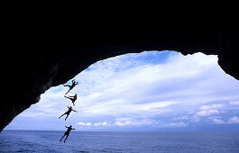 Free climber jumping into sea, Mallorca, Spain