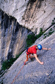 Man climbing up Il Ladro di Bagdad, Alpine climbing, Monte Cimo, Trentino, Italy