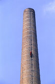 Worker climbing up factory chimney, Renovattion works on factory, Lower Austria, Glanzstoff Fabrik, St. Pölten, Niederösterreich