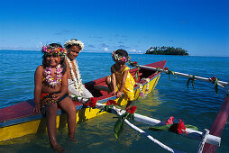Three girls in a canoe, Muri Beach, Rarotonga, Cook Islands, South Pacific