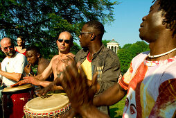 People drumming and dancing in the English Garden, Munich, Bavaria, Germany