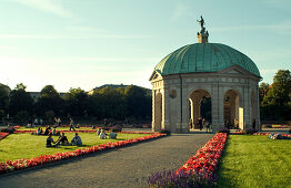 People sitting in front of Pavillon, 17th century, Hofgarten, Munich, Bavaria, Germany