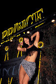Dancer in front of the neon signs of the Prince Nightclub, Riccione, Province of Rimini, Italy, Europe
