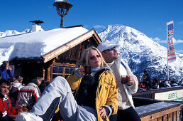 Couple having a warm drink at the Obstlerhuette, Soelden, Oetztal, Tyrol, Austria