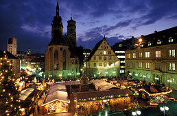 Christmas market on the Square Karlsplatz with church Stiftskirche and Schiller monument, Stuttgart, Germany