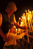 Pilgrims lighting a candle, El Rocío, Andalusia, Spain