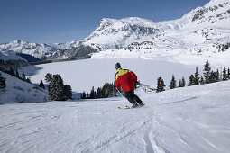 Skier skiing downhill, Kops lake, Wirl near Galtuer, Tyrol, Austria