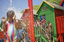 Tourists at changing rooms on St. James Beach, Cape Peninsula, Western Cape, South Africa