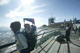 Woman with child on her back at the summit station, Zugspitze, Garmisch, Upper Bavaria, Bavaria, Germany