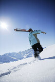 Woman going with skis uphill, Kühtai, Skifahrerin, Hohe Mut und Gaiskogel im Hintergrund, Kühtai, Tyrol, Austria