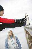 Young man stretching leg