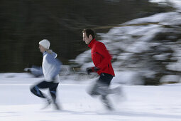 Young couple jogging on snow