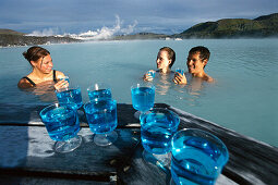 Visitors drinking cocktails, Blue Lagoon, geothermal spa with water from the power plant, Grindavik, Island