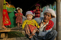 Portrait grandfather holding child, hill tribe, Burma, Myanmar