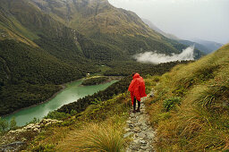 Hiker on Routeburn Track looking onto Lake Mackenzie, Mount Aspiring National Park, New Zealand, Oceania