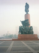 The statue of Lenin in the smog, October Square, Moscow, Russia
