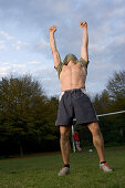 Young male soccer player jubilating, lifting t-shirt