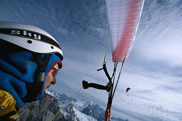 Paragliding Pilot in flight, Sella, Dolomites, South Tyrol, Italy