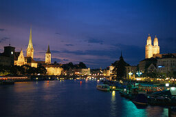 View over River Limmat to old town with Grossmuenster, Fraumuenster and St. Peter church in the evening, Zurich, Switzerland