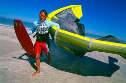 Man kiteboarding, coming back to beach