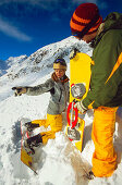 Two young people talking, snakeboarding in snow, Serfaus, Tyrol, Austria