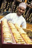 Young salesman with gold jewelry, Souk, Muscat, Oman, Middle East, Asia