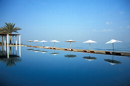 The pool reflecting sunshades, The Chedi Hotel, Muscat, Oman