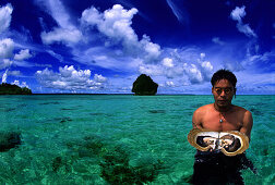 Pearl diver with oyster in the water, Palawan Island, Philippines, Asia