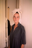 Young woman wearing a towel on her head, Berlin, Germany