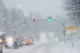 Snow flurry on a highway, traffic light, Bavaria, Germany
