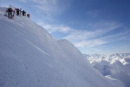 Four skier on ridge, way to extreme ski run, Nebelhorn, Oberstdorf, Bavaria, Germany