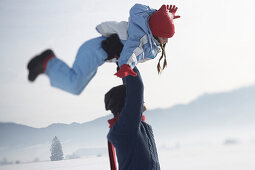 Father carring daughter over his head