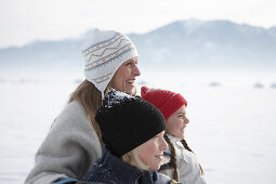 Mother with two children on snow