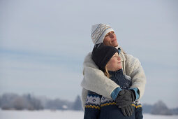 Mother hugging her son, winter scenery