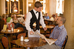 Waiter serving coffee ice, Cafe Central, Waiter serving coffee ice to a guest of Cafe Central, Vienna, Austria