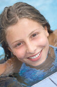 Smiling girl in a pool