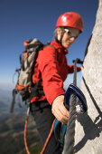 Young female climber on Donnerkogel fixed rope route, Dachstein Mountain, Austria