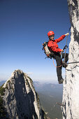 Young female climber on Donnerkogel fixed rope route, Dachstein Mountain, Austria