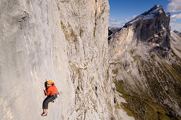 Climber on steep rock face, raetikon, Switzerland