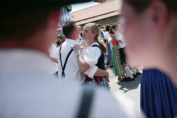 Couple in traditional bavarian clothes at celebration of 1st May, Muensing, Bavaria, Germany