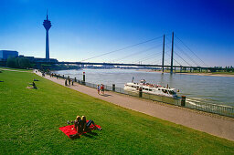 Shore of Rhine river with tower and bridge, Düsseldorf, Northrhine-Westfalia, Germany